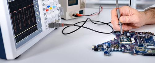 Industrial electrician performing electrical installations, working on high voltage wiring and inspecting switchboards for efficient power distribution