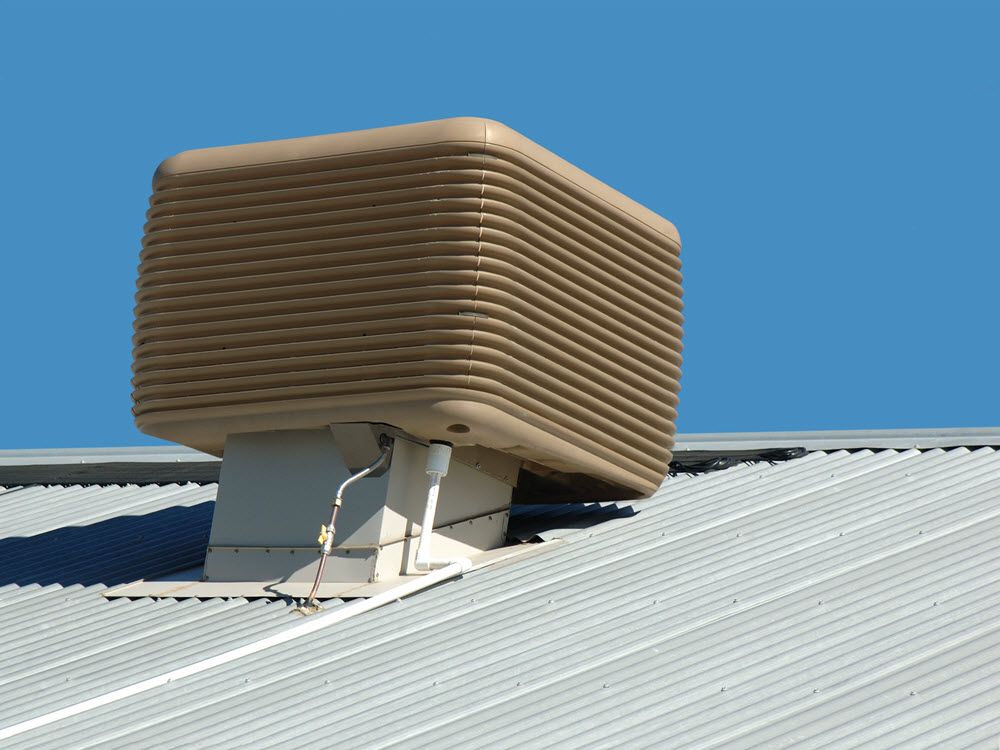 Master electricians installing an evaporative AC unit with secure electrical wiring, switchboards, and circuit breakers to ensure efficient electrical power management