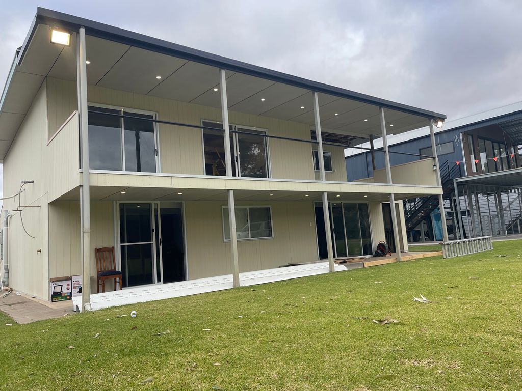 Electrician installing outdoor lighting during renovation for modern design home in Bowhill